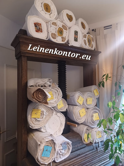 Bauernleinen und Leinenballen mit Stockkerzen auf Leinenpresse